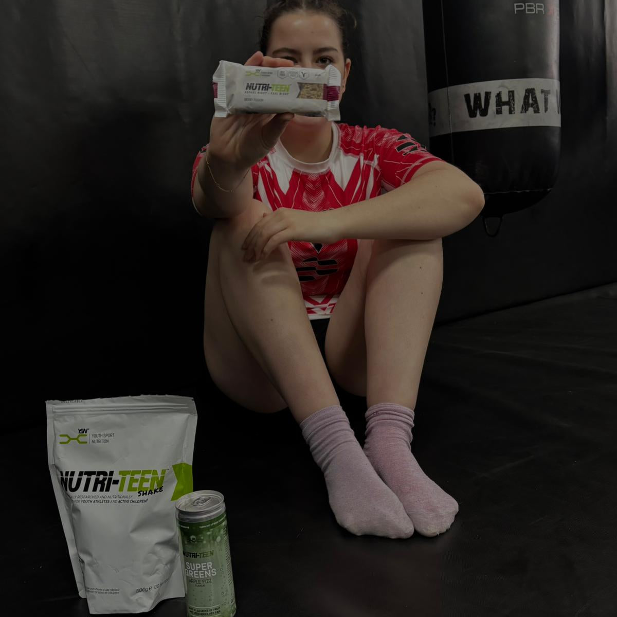 Female athlete holding a NUTRI-TEEN Energy Bar