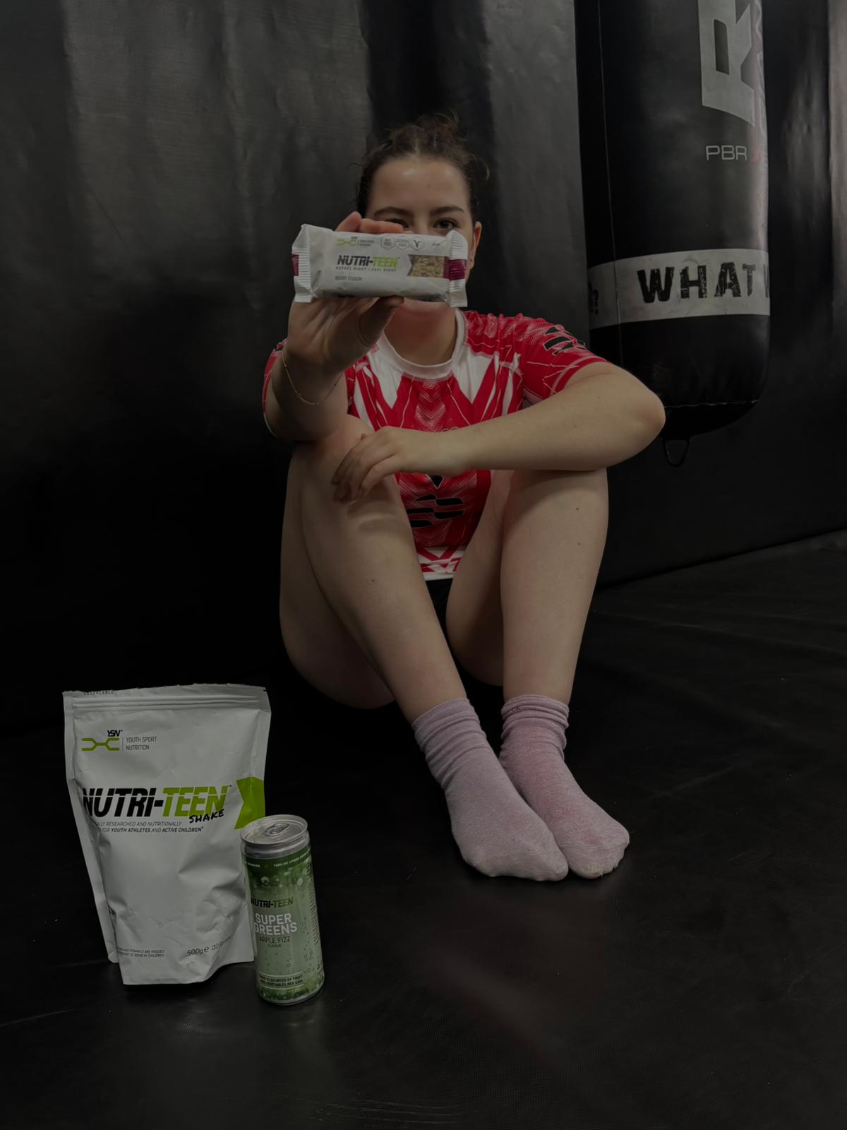 Female athlete holding a NUTRI-TEEN Energy Bar
